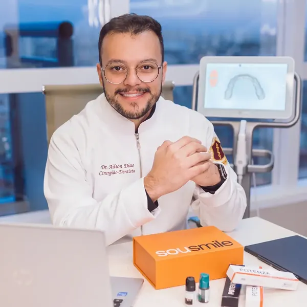 Dr. Ailton Silva, cirurgião-dentista, sorrindo no consultório da DS Odonto ao lado do scanner intraoral.